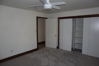 unfurnished bedroom with carpet, a closet, and ceiling fan