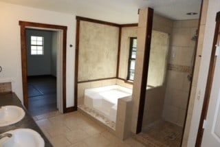 bathroom featuring tile patterned floors, vanity, and shower with separate bathtub