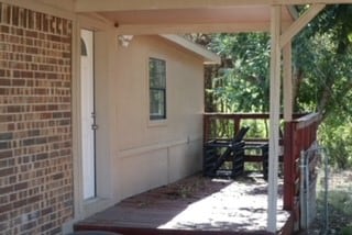 view of exterior entry with a deck