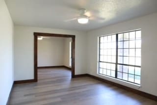 spare room featuring hardwood / wood-style floors, a textured ceiling, and ceiling fan