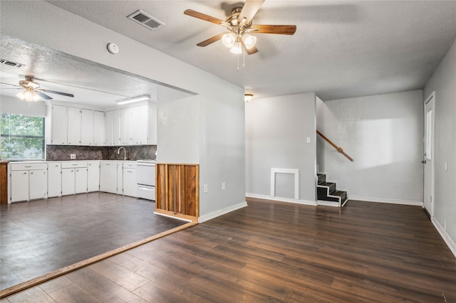 kitchen with dishwasher, white cabinetry, a textured ceiling, and dark hardwood / wood-style flooring