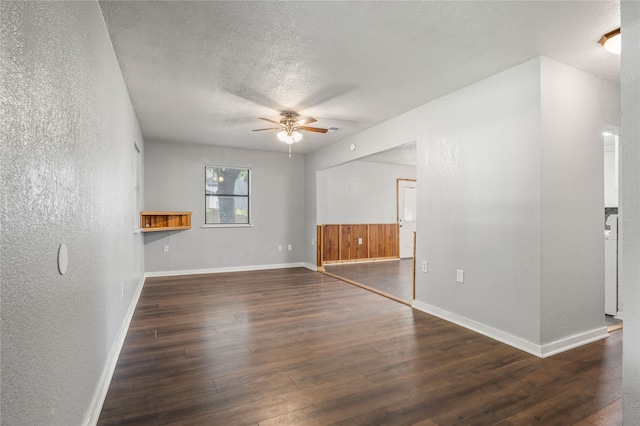 unfurnished room with ceiling fan, a textured ceiling, and dark hardwood / wood-style flooring