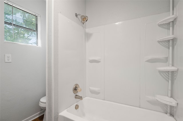 bathroom featuring toilet and shower / bath combination