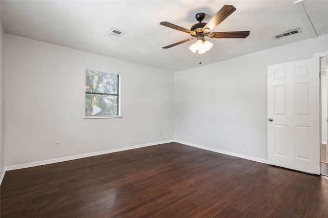 empty room featuring dark wood-type flooring and ceiling fan