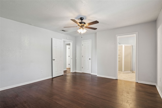 unfurnished room with ceiling fan, a textured ceiling, and dark hardwood / wood-style flooring