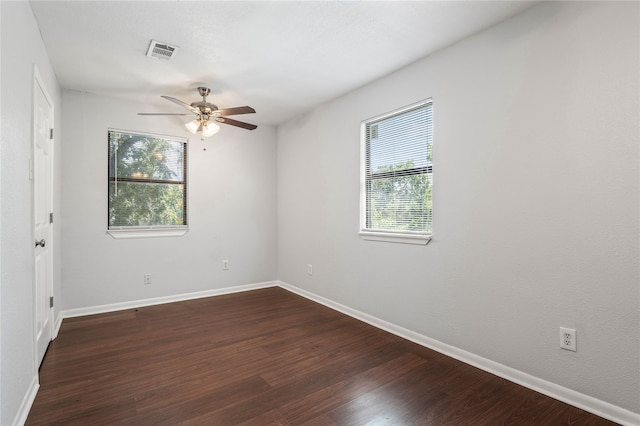 spare room with dark hardwood / wood-style floors and ceiling fan