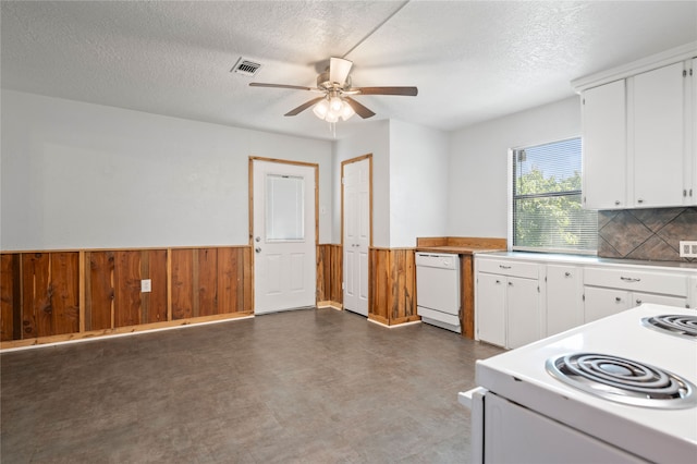 kitchen with white cabinets, tasteful backsplash, a textured ceiling, and white appliances