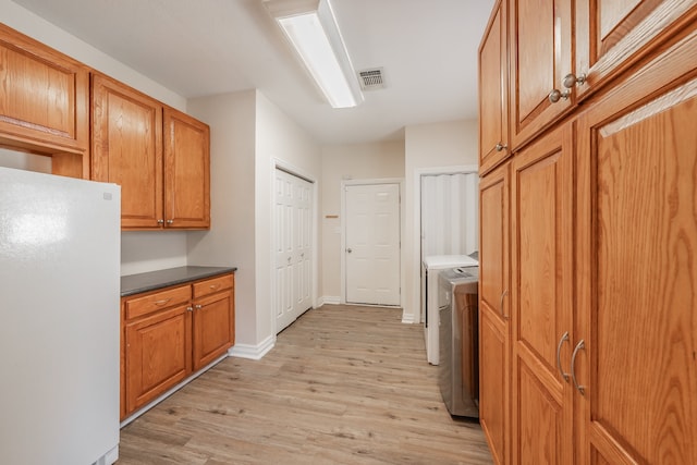 kitchen featuring white refrigerator and light hardwood / wood-style flooring