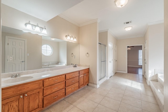 bathroom featuring tile patterned flooring, vanity, and crown molding