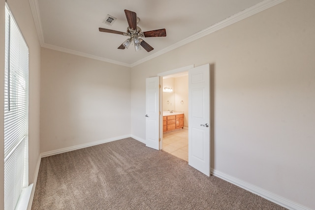 unfurnished bedroom with ensuite bathroom, sink, crown molding, ceiling fan, and light colored carpet