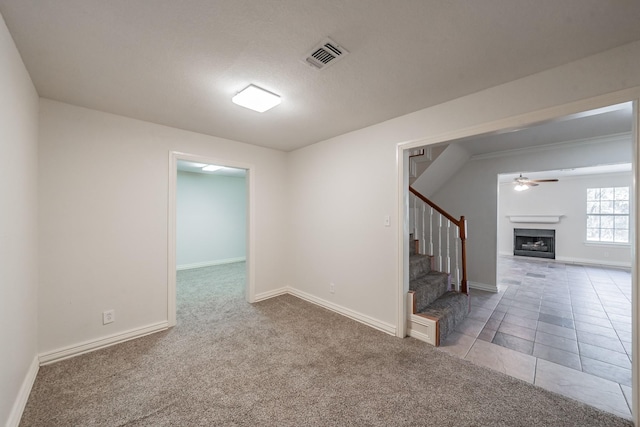 tiled spare room featuring ceiling fan