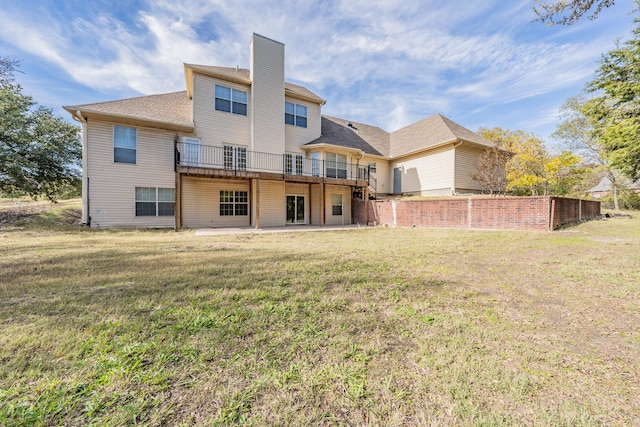 rear view of property featuring a yard