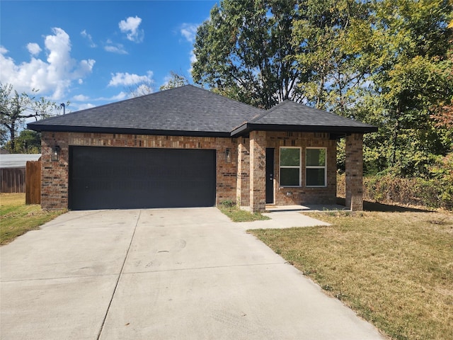 view of front facade with driveway, roof with shingles, brick siding, a front lawn, and an attached garage