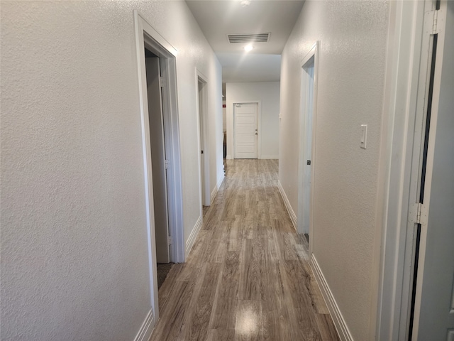 hallway featuring light hardwood / wood-style flooring