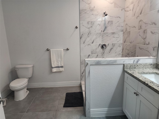 full bathroom with vanity, toilet, baseboards, walk in shower, and tile patterned floors