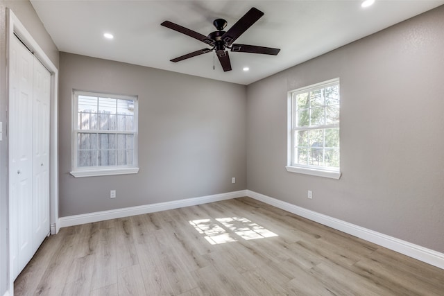 unfurnished bedroom featuring a closet, light hardwood / wood-style floors, and ceiling fan