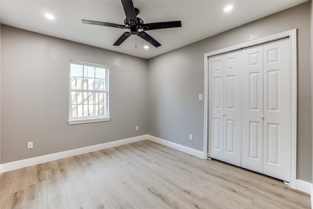 unfurnished bedroom featuring a closet, light wood-type flooring, and ceiling fan