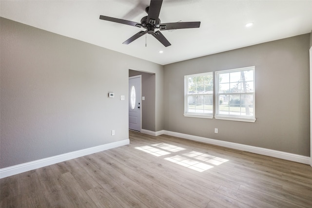 empty room featuring light wood-type flooring and ceiling fan