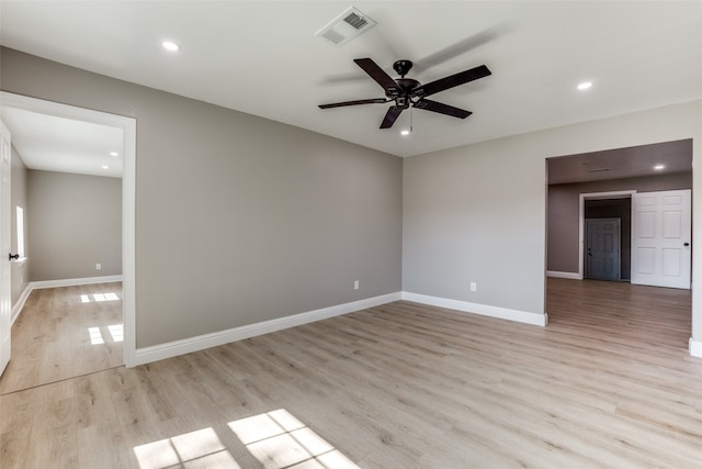 spare room with light wood-type flooring and ceiling fan