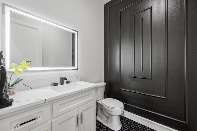 bathroom featuring vanity, toilet, and tile patterned flooring