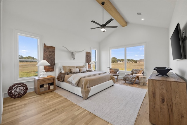 bedroom with ceiling fan, beam ceiling, high vaulted ceiling, and light hardwood / wood-style flooring