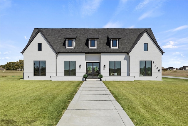 back of house with french doors and a yard