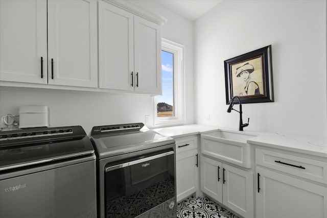 laundry room featuring a sink, separate washer and dryer, cabinet space, and light tile patterned floors