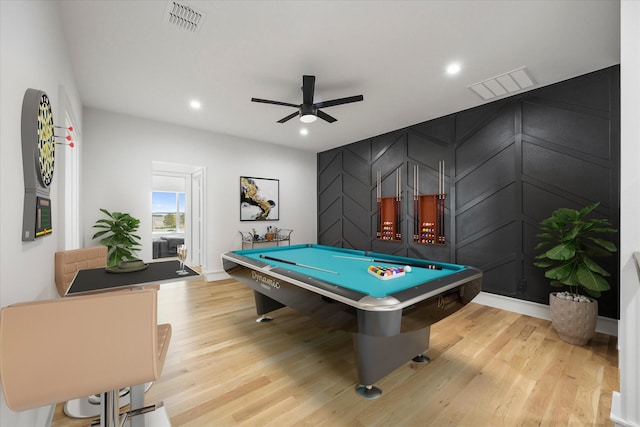 rec room featuring wood finished floors, a decorative wall, billiards, visible vents, and a ceiling fan