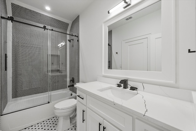 full bathroom featuring enclosed tub / shower combo, vanity, tile patterned flooring, and toilet