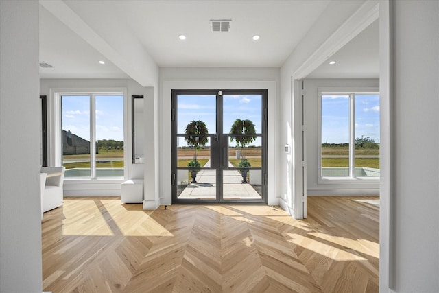 doorway to outside featuring recessed lighting, visible vents, french doors, and plenty of natural light
