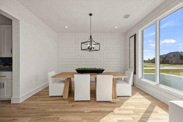 unfurnished dining area with recessed lighting, a chandelier, visible vents, light wood-style flooring, and baseboards