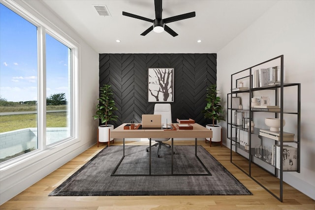 office with recessed lighting, an accent wall, baseboards, visible vents, and a ceiling fan