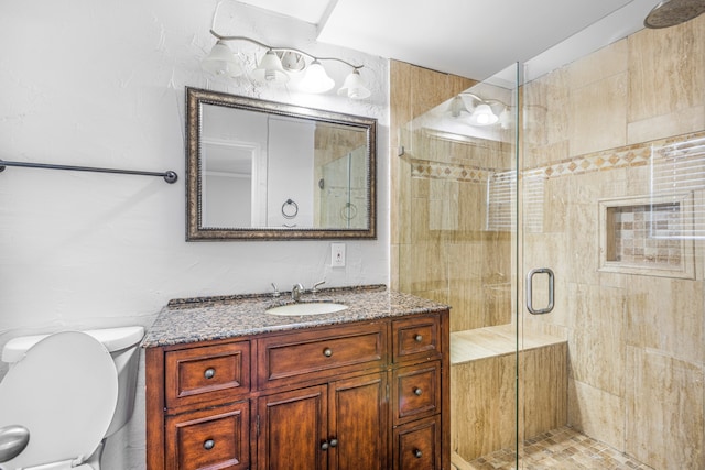 bathroom featuring a shower with door, toilet, and vanity