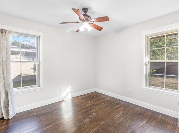 empty room featuring dark wood-type flooring and ceiling fan