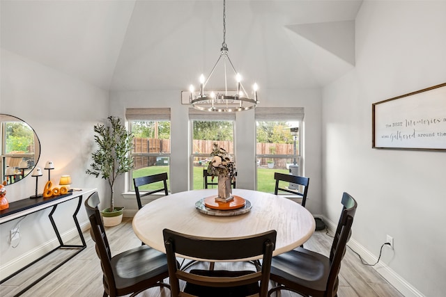 dining area with a notable chandelier and high vaulted ceiling