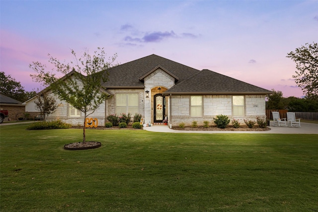 view of front of home with a yard