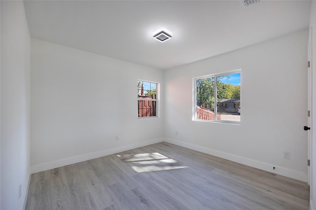 spare room featuring light hardwood / wood-style flooring