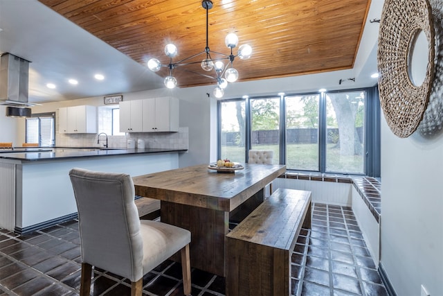 dining room with an inviting chandelier, wooden ceiling, and lofted ceiling