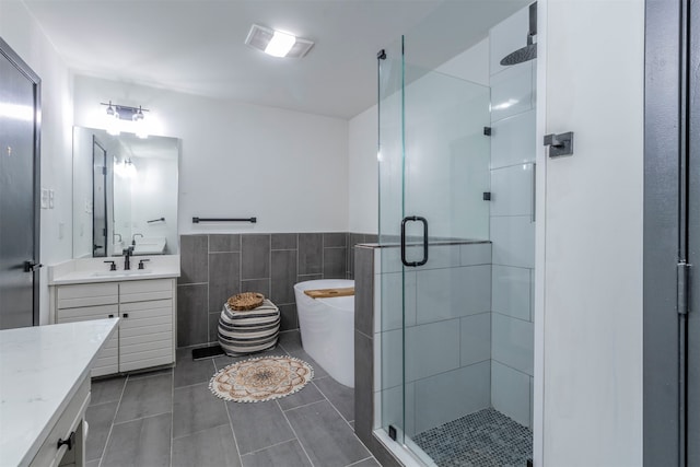 bathroom with tile walls, vanity, plus walk in shower, and tile patterned floors