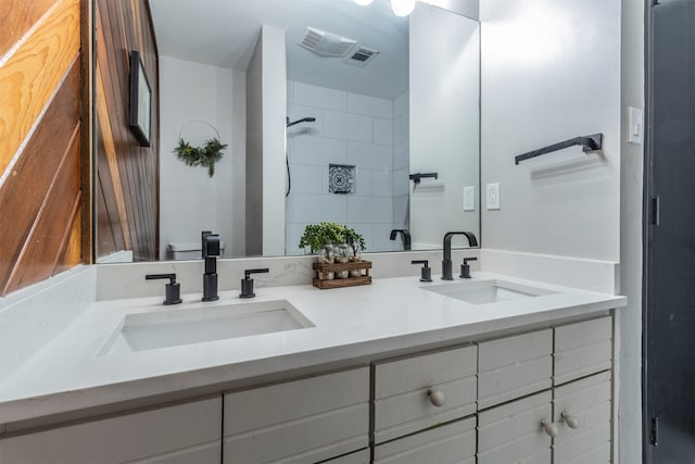 bathroom featuring vanity and tiled shower