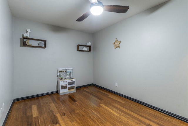 spare room with dark hardwood / wood-style floors and ceiling fan