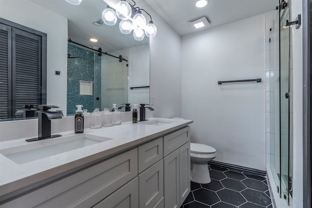 bathroom with vanity, toilet, a shower with shower door, and tile patterned flooring