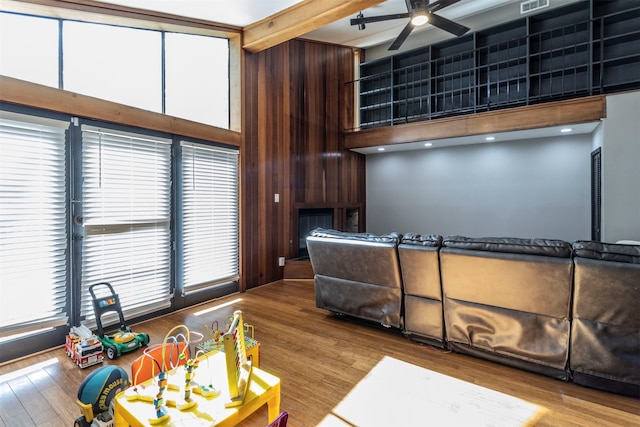 interior space with a towering ceiling, hardwood / wood-style floors, and ceiling fan