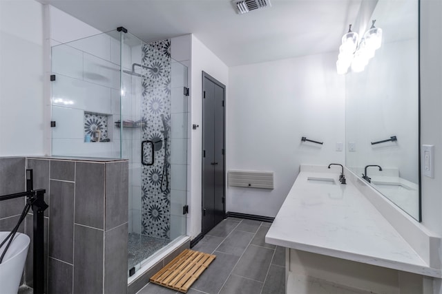 bathroom with vanity and an enclosed shower