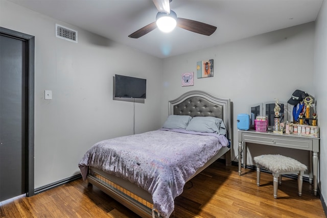 bedroom with hardwood / wood-style floors and ceiling fan