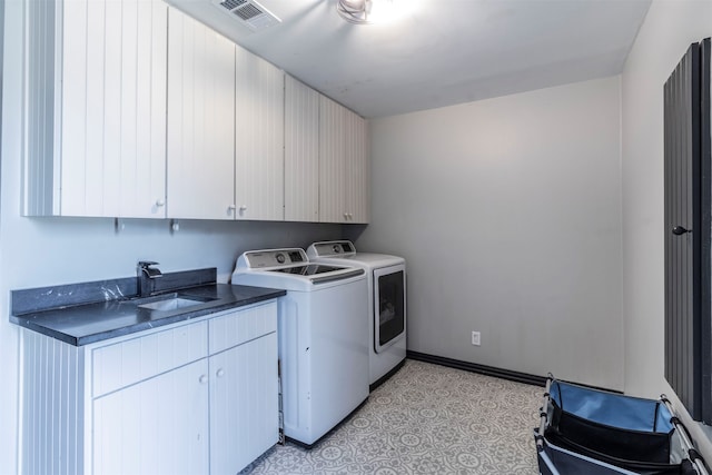 laundry area with cabinets, sink, and washing machine and clothes dryer