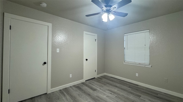 unfurnished bedroom with ceiling fan and light hardwood / wood-style floors