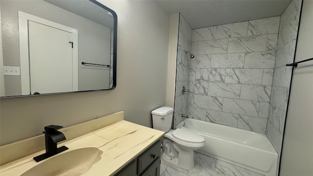 full bathroom featuring vanity, tiled shower / bath combo, and toilet