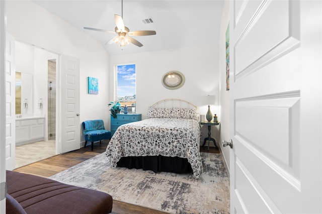 bedroom featuring ensuite bath, hardwood / wood-style floors, and ceiling fan