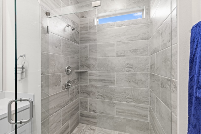 bathroom featuring a shower with door